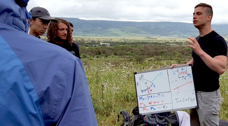 Teaching slope stability analysis on a whiteboard to students during an engineering geology field practical